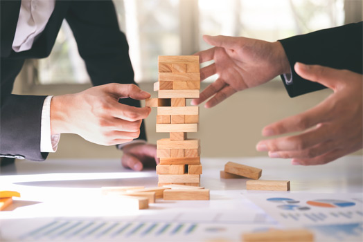 Business People Playing Jenga